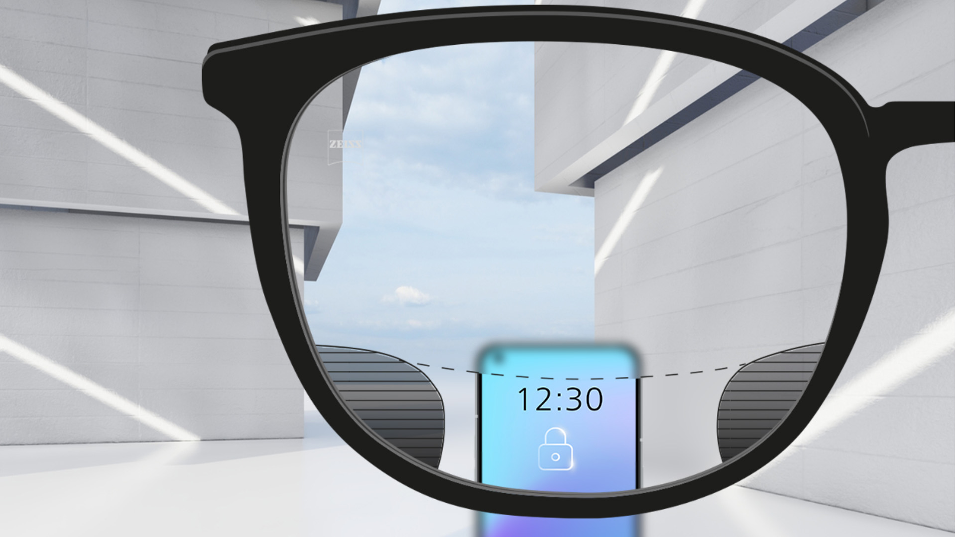 Imagen de un punto de vista con lentes ZEISS Digital SmartLife con un smartphone y el lente completamente nítido en la zona superior e inferior del lente con zonas borrosas a izquierda y derecha.